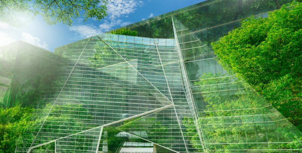 Sustainble green building. Eco-friendly building. Sustainable glass office building with tree